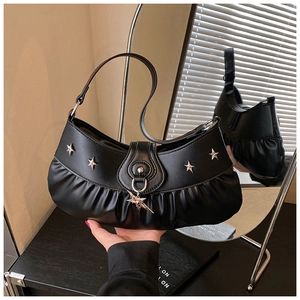 Detail of black crescent shoulder bag with pleated leather and silver star rivets