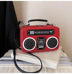 Macro shot of red sequin radio-shaped bag detailing with FM dial and PU handle