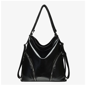 Detailed front view of a black glossy leather shoulder bag with decorative dual zippers
