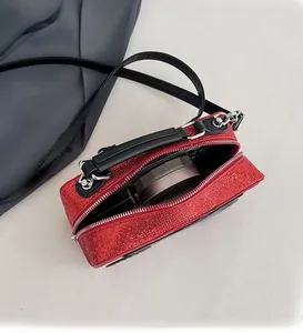 Macro shot of red glitter square bag showing internal space and black fabric lining