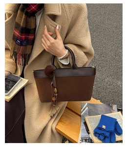 Close-up of leopard print patchwork shoulder bag with tassel charm in autumn outdoor setting