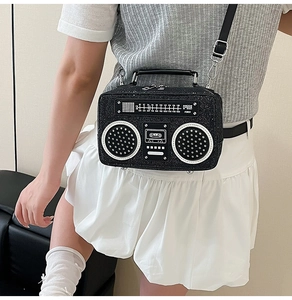 Macro detail of retro boombox crossbody bag showing glitter sequins and vintage radio dial