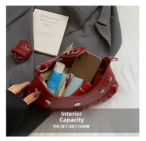 Top view of red crescent bag showing inner capacity for phone and cosmetics