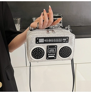 Macro detail of silver sequined radio bag showing realistic speaker decor and tuning dial