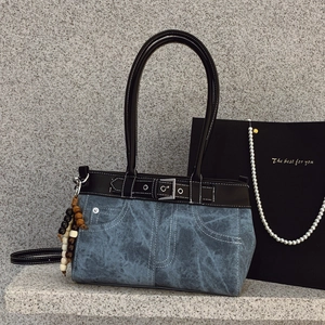 Retro denim patchwork shoulder bag with leather handles and colorful beaded charm