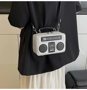 Close-up of retro radio shaped silver glitter shoulder bag with detailed dial design