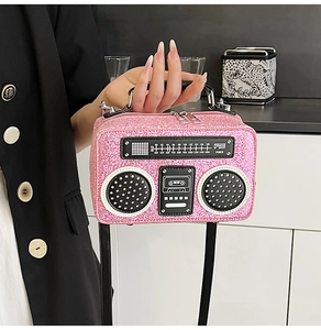 Detail of pink sequin radio-shaped handbag with realistic vintage dials and knobs