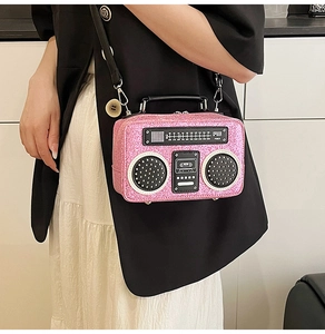 Detail of creative pink glitter radio-shaped crossbody bag with realistic dial and speaker