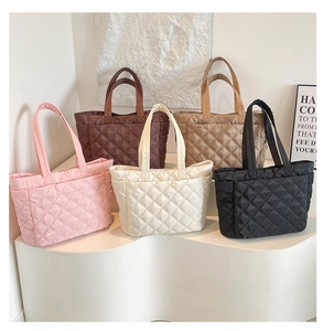 Close-up of quilted tote bags displayed in five colors: pink, brown, white, khaki, and black