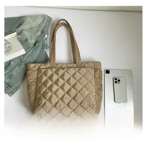 Quilted khaki tote bag size comparison with tablet and phone showing large capacity
