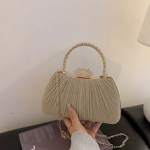 Champagne evening clutch bag with pearl handle and sequined vertical pleats