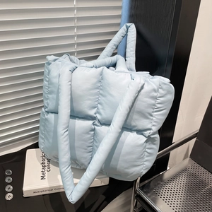 Light blue quilted tote bag in padded nylon with large capacity and shoulder straps
