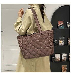 Quilted tote bag detail showing large capacity and soft nylon texture on shoulder