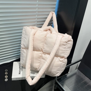 Chic light pink quilted tote bag with padded grid texture and versatile double straps