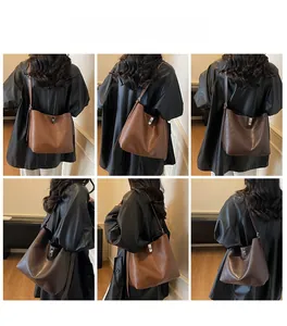 Detail view of large matte leather bucket tote bag in caramel and coffee brown tones