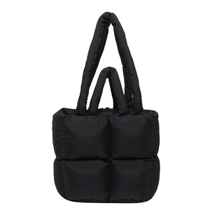 Modern black quilted puffer tote bag with padded handles and spacious interior design