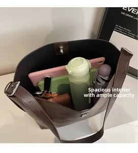 Interior view of large brown tote bag showing spacious capacity for tablets and daily items