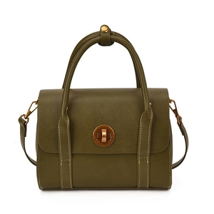 Retro dark green leather shoulder bag with gold metal clasp on white background
