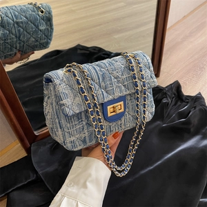 Denim blue quilted chain bag with gold twist lock and elegant crossbody strap