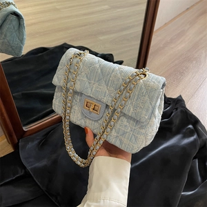 Light blue tweed shoulder bag with diamond quilted texture and gold chain strap
