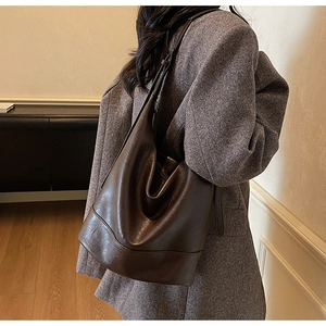 Detailed view of a chocolate brown hobo bag with smooth leather finish and slouchy design