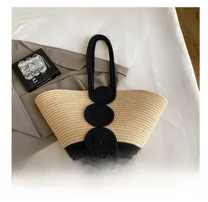 Detail of handwoven tote bag featuring contrast black circular patches and fine texture