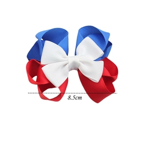 Detail view of red white and blue striped bow hair clip showing 8.5cm measurement