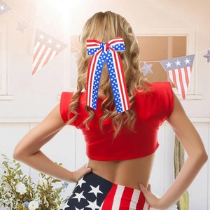 Large Independence Day hair bow with US flag stars and stripes on long golden hair