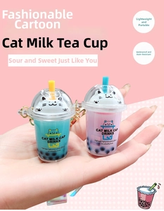 Detail of cute cat bubble tea keychain featuring liquid sand effect and metal clasp