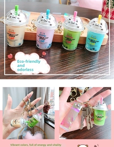 Close-up of cat-themed bubble tea keychains with holographic straps in four colors