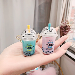 Cute cat boba tea keychains in mint green and lilac with golden metal chains