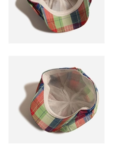 Detailed view of the checkered cotton flat cap featuring inner lining and care label detail