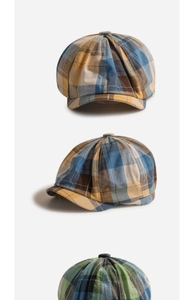Detail showing vintage plaid newsboy caps for kids in bright and dark color patterns
