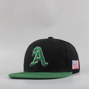 Close-up of green embroidered 'A' letter and American flag patch on a black hip hop cap