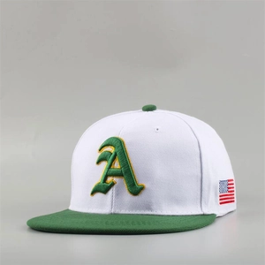 Detailed close-up of white and green snapback hat featuring gothic letter A embroidery