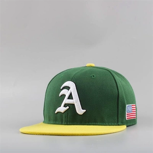 Close-up of the detailed white gothic letter A embroidery on a green flat brim cap