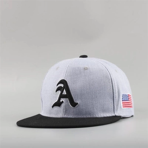 Detail of grey snapback cap with black brim featuring gothic A letter and flag patch