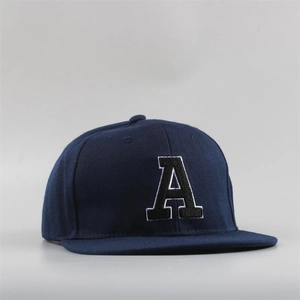Close-up of premium navy blue snapback hat featuring 3D embroidered letter A with white border