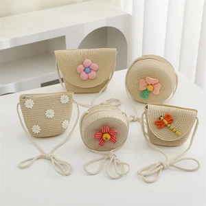 Close-up of children's straw bags featuring cute floral embroidery and cotton straps