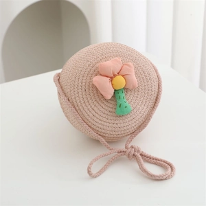 Detail of pink woven straw bag for girls with a cute floral 3D flower decoration