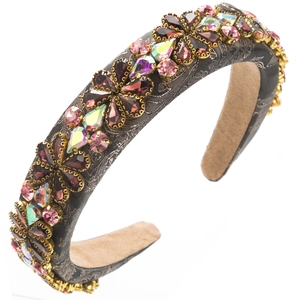 Detailed view of Baroque headband with pink glass crystal flowers on dark textured fabric