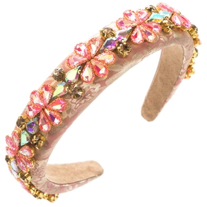 Close-up of pink baroque headband with gold jacquard fabric and colorful rhinestone flowers