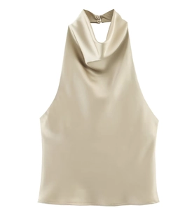Detail of champagne satin halter top featuring a cowl neck and pearl button closure