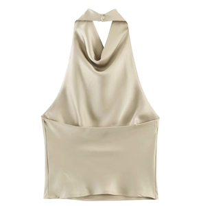 Detail of champagne gold satin halter top showing metallic buckle and silky texture