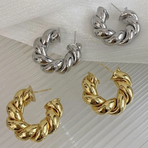 Golden and silver twisted hoop earrings with chunky weave texture in C-shape design
