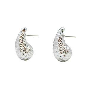 Detail of silver drop earrings featuring a unique hammered metallic texture and stud backing