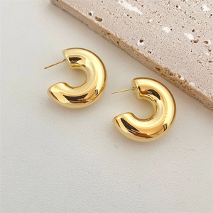 Polished chunky gold C-shaped hoop earrings with a minimalist thick tubular design