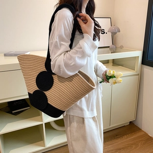 Handmade woven tote bag in beige and black contrast with elegant shoulder straps
