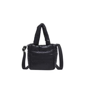 Black padded puffer tote bag with quilted texture and adjustable crossbody shoulder strap