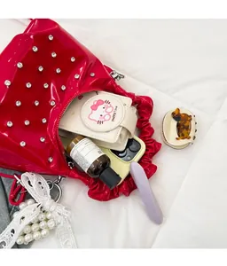 Detailed interior view of red pleated cloud bag showing large storage capacity and items